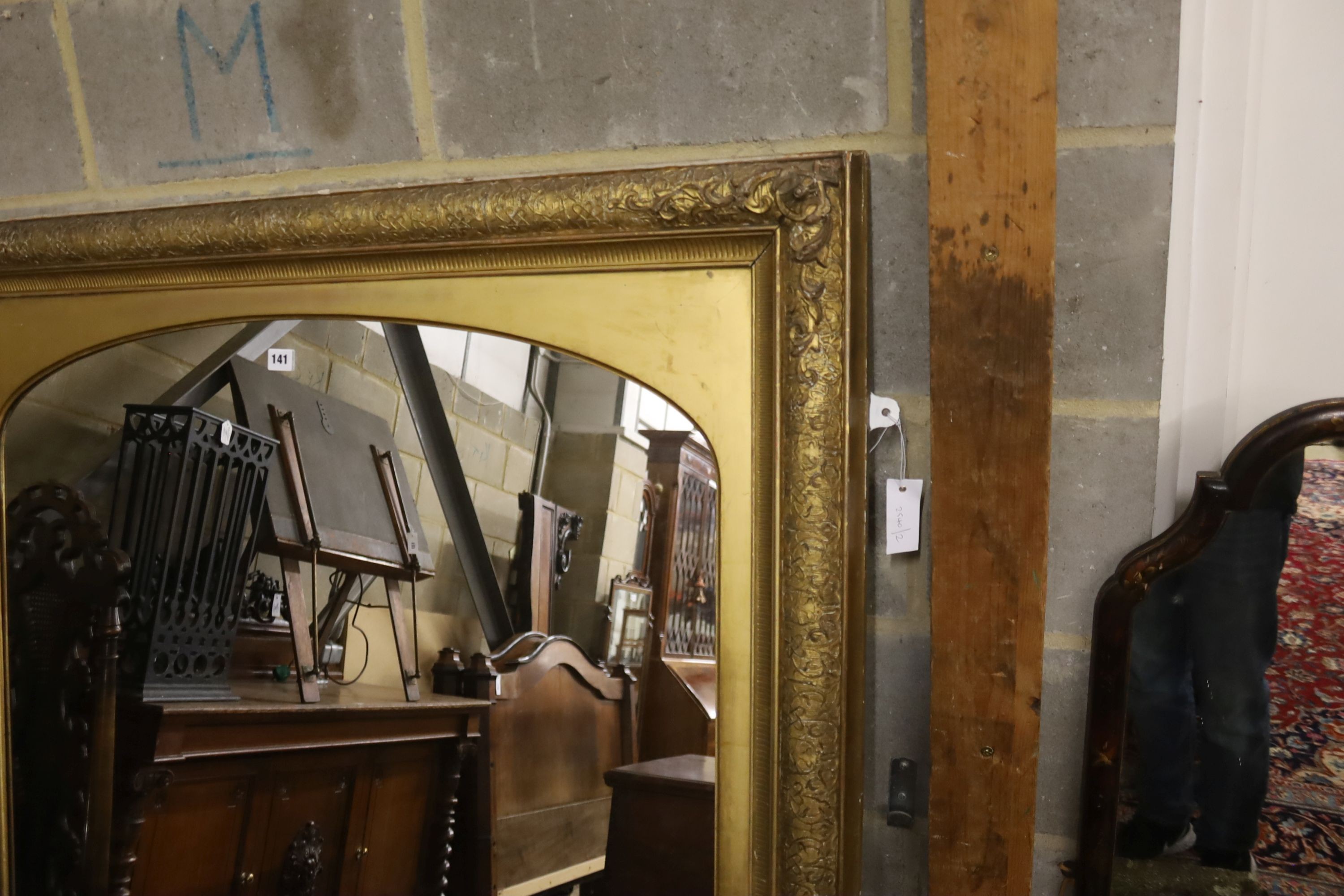 A giltwood and gesso overmantel mirror with arched plate, width 115cm, height 112cm